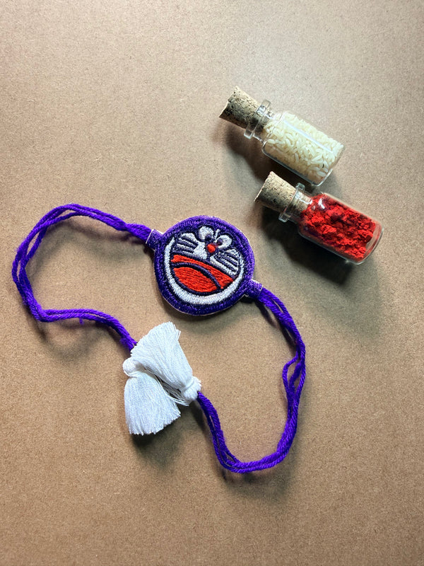 Charm Rakhi with Tassel - Purple Thread image 1